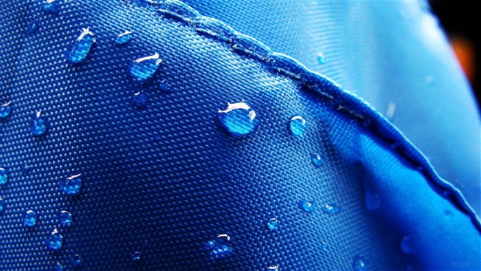 Water Drops on Blue Textured Fabric 4K