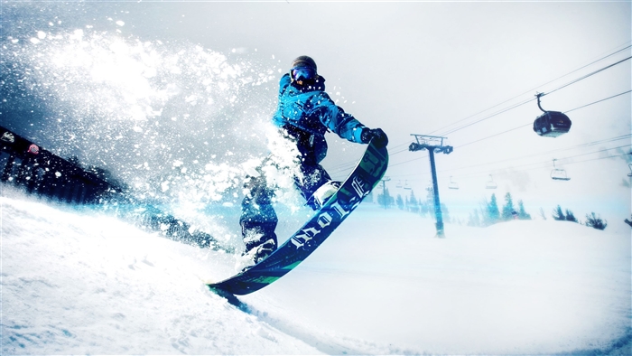 Snowboarder in blue jacket on a snowy slope with ski lift