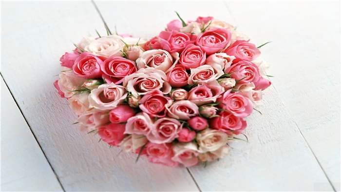 Heart-shaped bouquet of pink and white roses