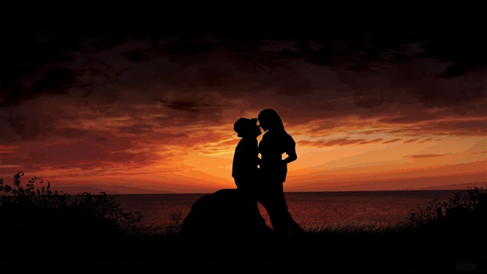 Couple kissing at sunset