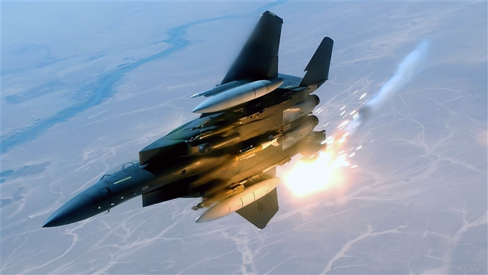 F-15E Strike Eagle launching missiles over desert