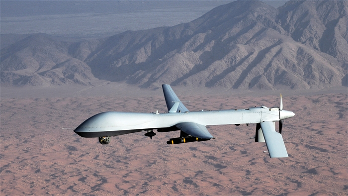 MQ-1 Predator drone flying over desert mountains 4K