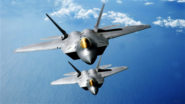 Two F-22 Raptors flying over the Pacific Ocean