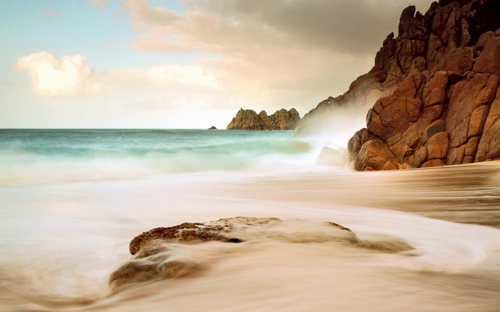 Long exposure of waves crashing on a rocky beach