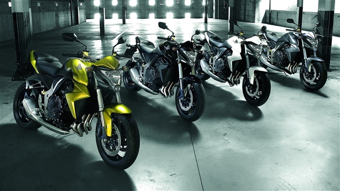 Four Honda Motorcycles in a Garage