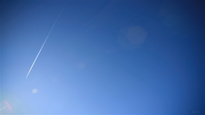Airplane contrail in a clear blue sky 4K