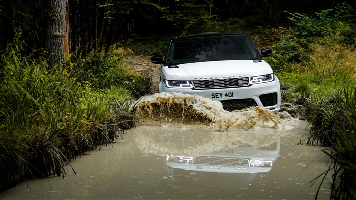 White Range Rover Sport driving through water