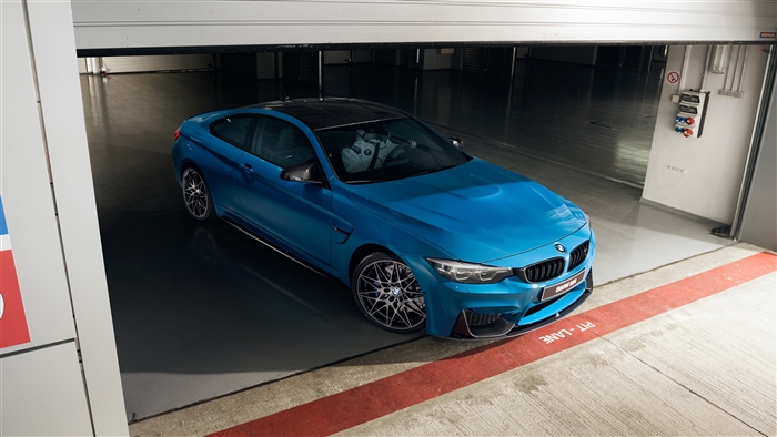 Blue BMW M4 Coupe Competition in garage