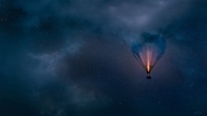 Hot air balloon flying in starry night sky