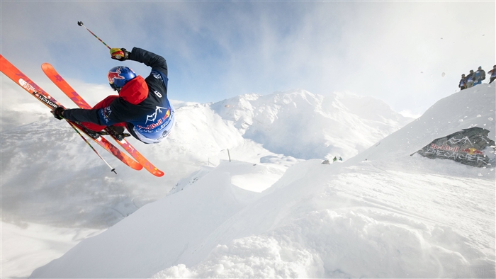 Red Bull skier performing a trick in the mountains