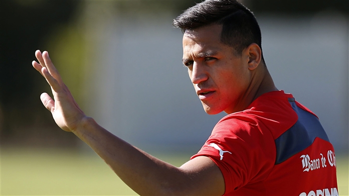 Alexis Sanchez wearing red Puma jersey