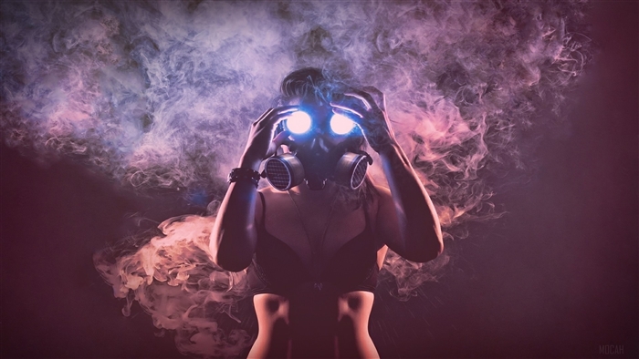 Woman in gas mask with glowing eyes and smoke