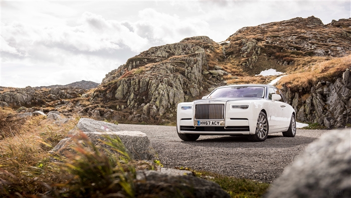 White Rolls Royce Phantom on a rocky mountain road 4K