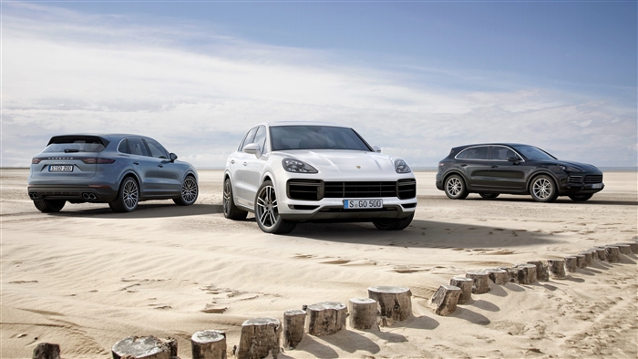 Three Porsche Cayenne SUVs on a Beach