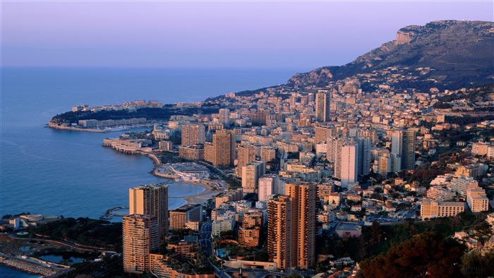 Cityscape of Monaco by the sea at sunset