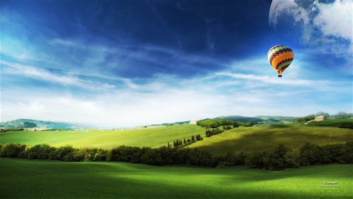 Hot air balloon over rolling green hills