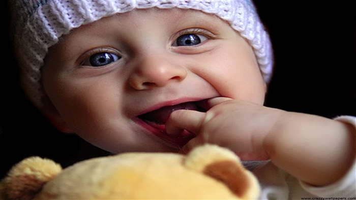 Cute baby wearing a white hat playing with a doll 4K