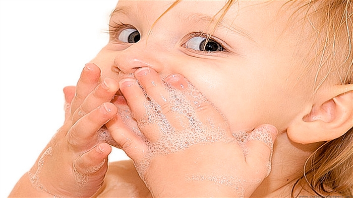 Cute baby playing with soap bubbles