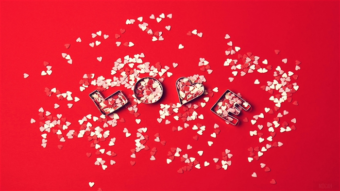 Love hearts cookie cutters on red background 4K