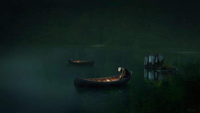 Man in a boat on a lake at night