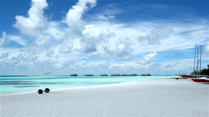 Beach with Overwater Bungalows and Sailboats 4K