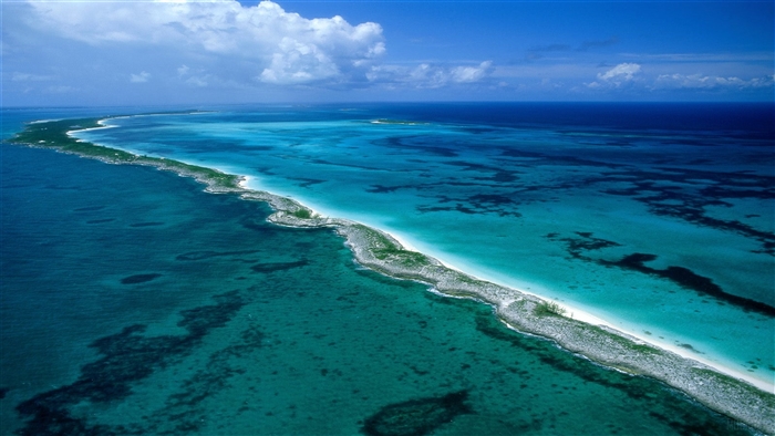 Aerial view of a long, narrow island in the Bahamas