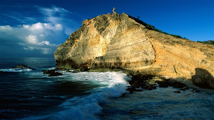 Rocky cliff face meeting the ocean in Guadeloupe