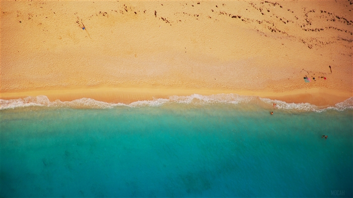 Aerial view of a sandy beach with turquoise water