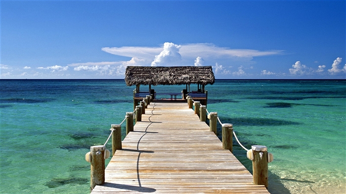 Wooden pier with thatched hut in the Bahamas 4K