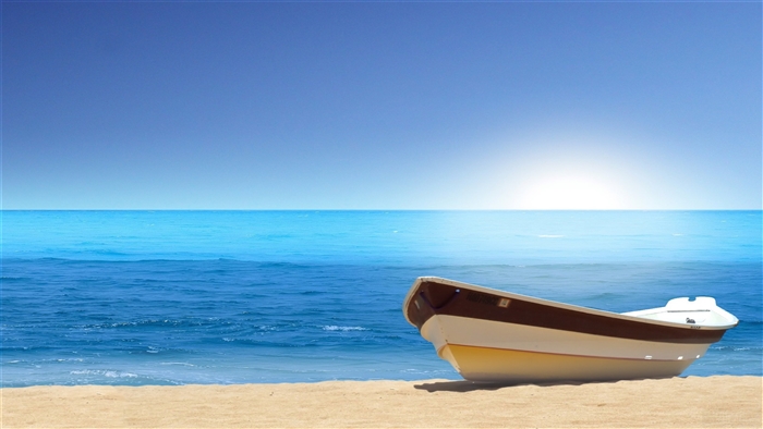 Boat on a sandy beach with the sea and sky