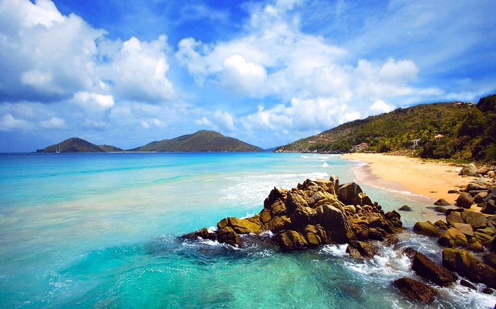 Tropical beach with turquoise water and rocky shore