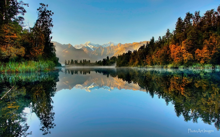Mountain reflection in a calm lake at sunrise