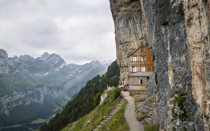Restaurant built into a cliff face with mountains