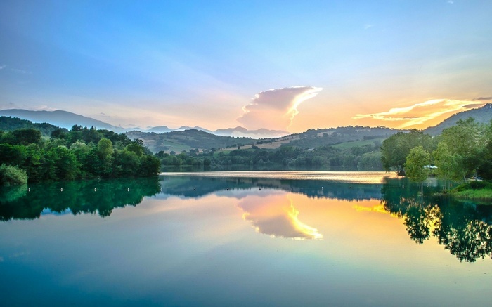 Lake and hills at sunset with reflections