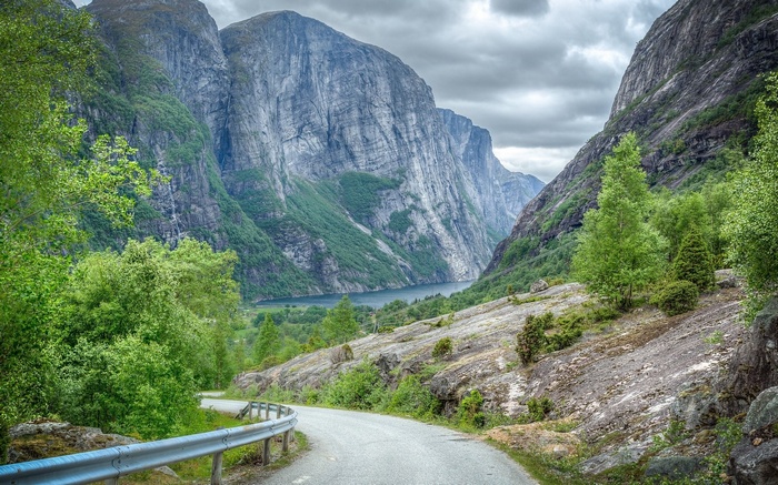 Winding road through a mountain valley with a fjord
