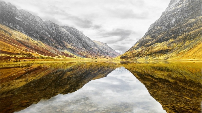 Mountain valley reflected in a calm lake