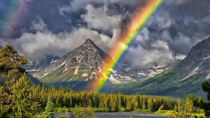 Rainbow over mountains and lake