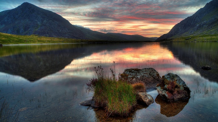 Mountain lake at sunset with colorful sky reflection
