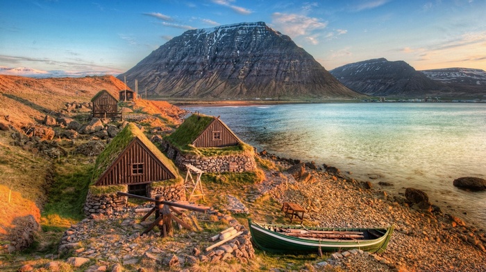Traditional turf-roofed houses by a fjord in Iceland