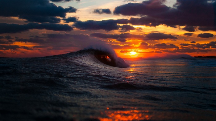 Wave crashing at sunset