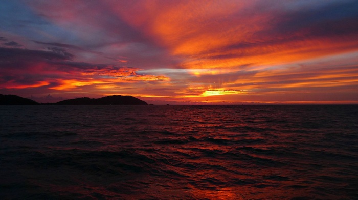 Sunset over the ocean with islands