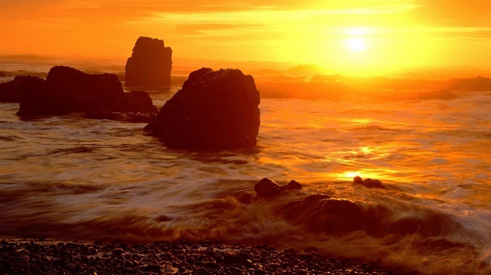 Sunset over rocky ocean coast