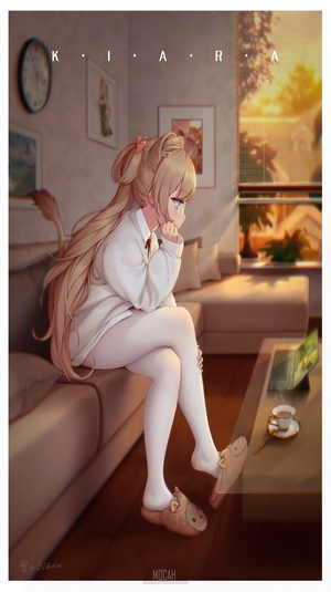 Kiara sitting on a couch with a laptop and coffee
