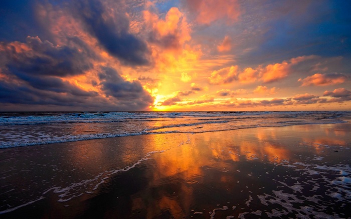 Sunset over the ocean with dramatic clouds