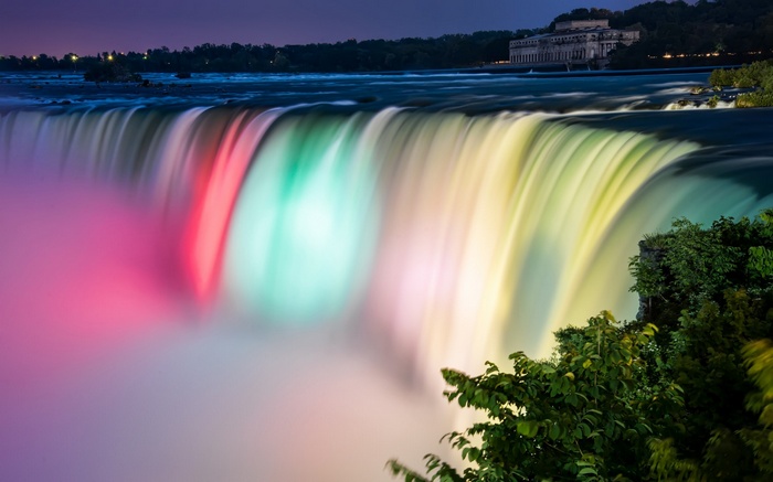 Niagara Falls illuminated with colorful lights at night