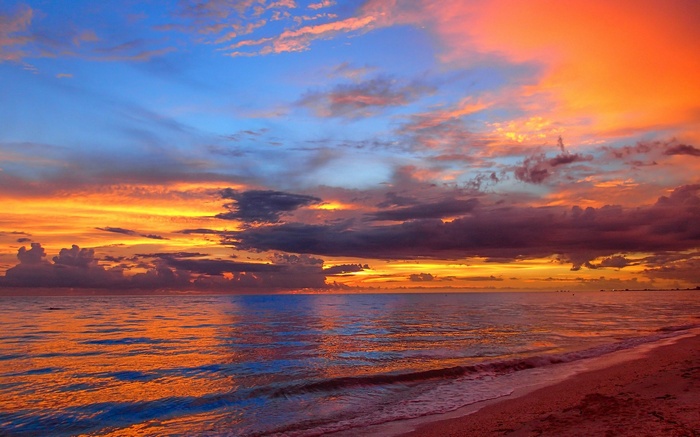 Sunset over the ocean with colorful clouds