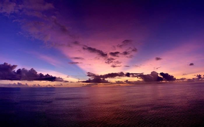 Ocean and sky at sunset with colorful clouds