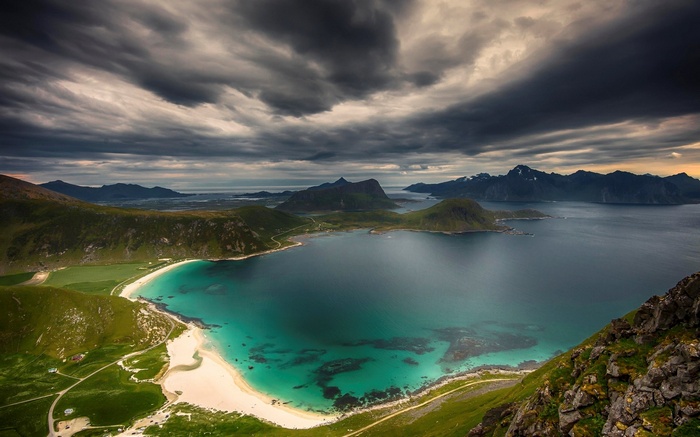 Dramatic cloudy sky over a Norwegian fjord and beach