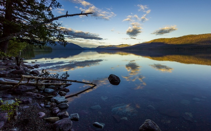 Lake reflection at sunset with mountains and trees