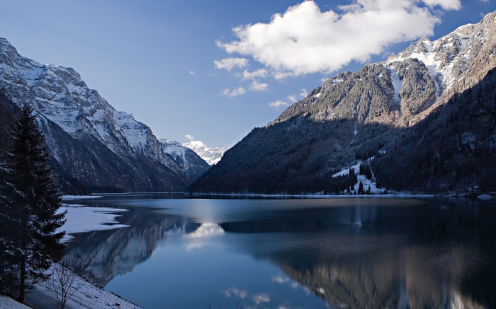 Snow-capped mountains reflected in a calm lake